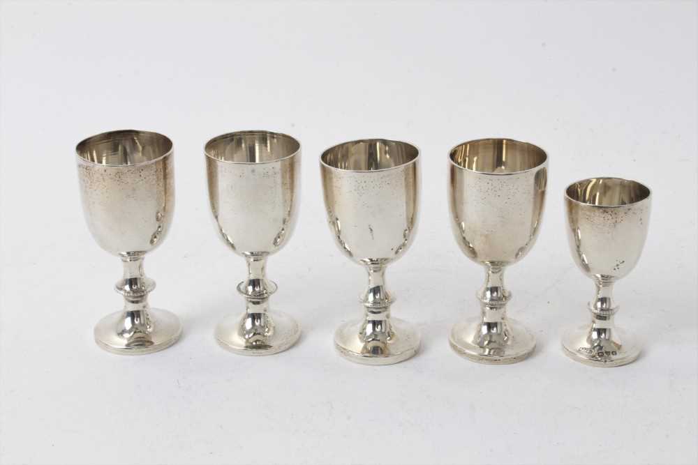 Lot 211 - Four Edwardian silver egg cups with beaded collars