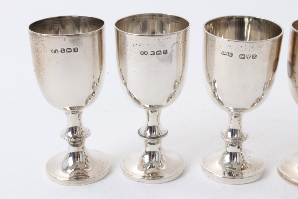 Lot 211 Four Edwardian silver egg cups with beaded