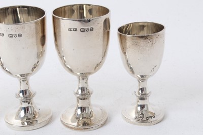 Lot 211 - Four Edwardian silver egg cups with beaded collars