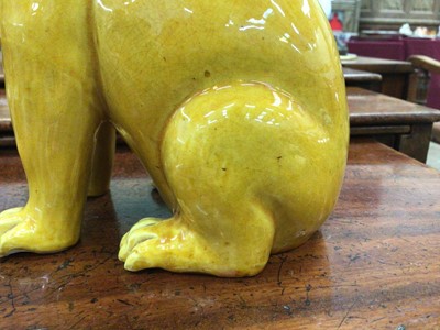 Lot 69 - Pair of Chinese yellow glazed models of seated cats, probably Republic period, 17cm high