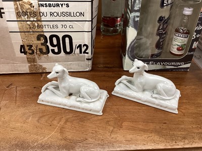 Lot 660 - Two white glazed porcelain models of dogs