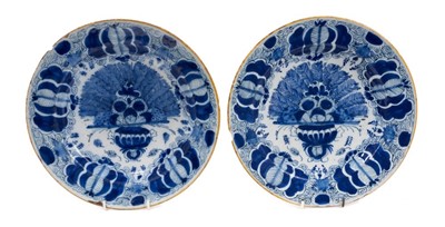 Lot 73 - Pair of 18th century Dutch blue and white peacock pattern delftware dishes, yellow-painted rims, marks to backs, 27cm diameter