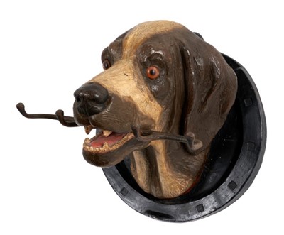 Lot 937 - Late 19th/early 20th century painted terracotta hound mask whip holder within a horseshoe, 30cm wide