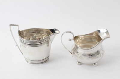 Lot 222 - Georgian silver oval form helmet-shaped jug with reeded borders, (London 1799), 11.5cm high, 4ozs and Victorian silver helmet-shaped milk jug on ball feet (marks rubbed) approx. 4.5ozs (2)