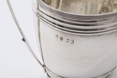 Lot 222 - Georgian silver oval form helmet-shaped jug with reeded borders, (London 1799), 11.5cm high, 4ozs and Victorian silver helmet-shaped milk jug on ball feet (marks rubbed) approx. 4.5ozs (2)