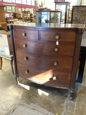 Lot 1374 - George IV mahogany bow front chest of drawers, having two short over three long graduated drawers, each with original lion mask handles, between projecting fluted columns on spool feet, 116cm wide...