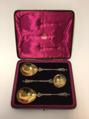 Lot 43 - Cased set three Victorian silver gilt serving spoons/sifter spoon
