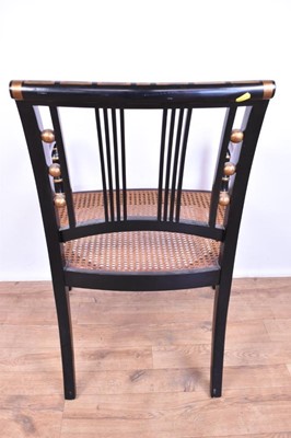 Lot 1359 - Pair of Regency style ebonised and gilt heightened open armchairs, each with Greek key top and seat rails, caned seat on splayed ring turned legs