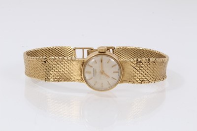Lot 612 - 18ct gold Longines wristwatch with mechanical movement in circular gold case on integral gold Milanese bracelet, case 16mm diameter.