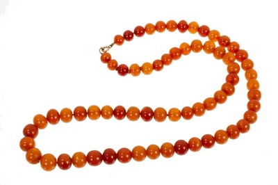 Lot 492 - Old amber necklace with a string of graduated amber beads. Approximately 57cm length.