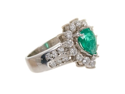 Lot 449 - Emerald and diamond cluster ring with a pear cut emerald measuring approximately 8mm x 6mm surrounded by a border of thirteen brilliant cut diamonds in claw setting flanked by twelve channel-set br...