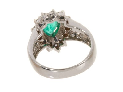 Lot 449 - Emerald and diamond cluster ring with a pear cut emerald measuring approximately 8mm x 6mm surrounded by a border of thirteen brilliant cut diamonds in claw setting flanked by twelve channel-set br...