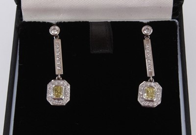 Lot 460 - Pair of yellow diamond and white diamond pendant earrings, each with a rectangular cushion cut yellow diamond measuring approximately 4.3mm x 3.6mm x 2.4mm surrounded by brilliant cut diamonds susp...