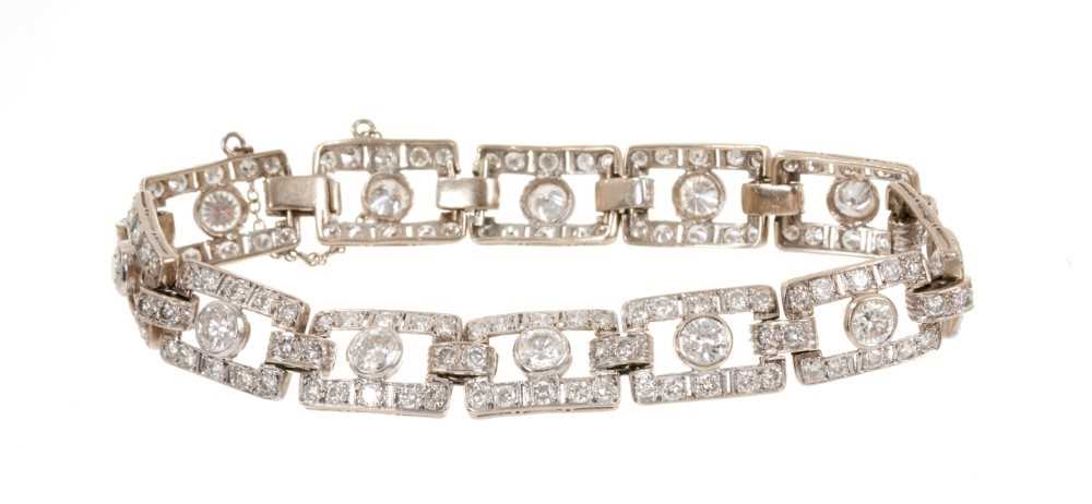 Lot 418 - Art Deco style diamond bracelet articulated rectangular openwork panels, each with a round brilliant cut diamond within a diamond border, in white gold setting. Estimated total diamond weight appro...