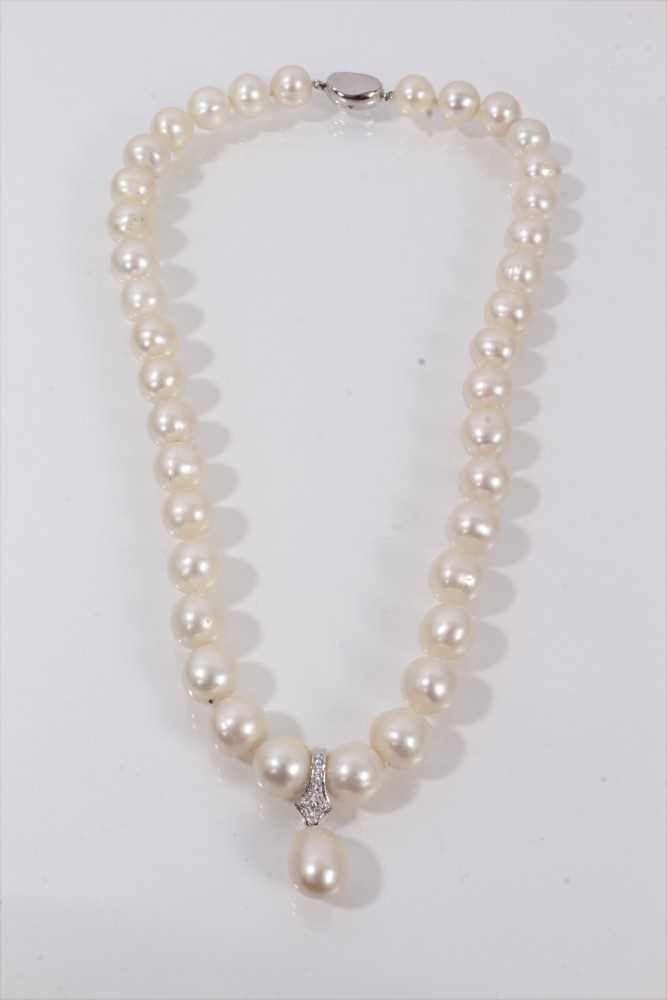 Lot 739 - Cultured pearl necklace with a string of 10.5mm-11.5mm cultured pearls suspending a detachable pear shaped cultured pearl pendant drop, 47cm.