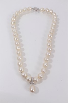 Lot 551 - Cultured pearl necklace with a string of 10.5mm-11.5mm cultured pearls suspending a detachable pear shaped cultured pearl pendant drop, 47cm.