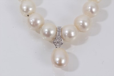 Lot 739 - Cultured pearl necklace with a string of 10.5mm-11.5mm cultured pearls suspending a detachable pear shaped cultured pearl pendant drop, 47cm.