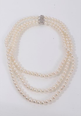 Lot 552 - Cultured pearl three-stand choker necklace with 5.5mm cultured pearls on an18ct white gold and diamond clasp, approximately 36cm.