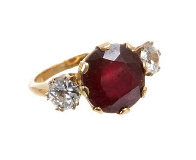 Lot 440 - Ruby and diamond three stone ring with an oval mixed cut ruby measuring approximately 12mm x 11.5mm x 7.25mm flanked by two old cut diamonds, all in claw setting on gold shank. Estimated total diam...