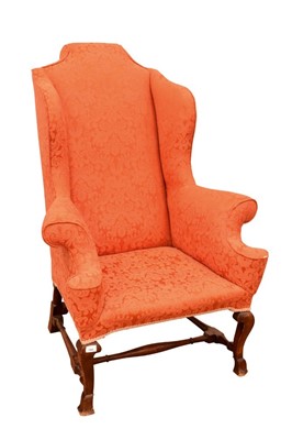 Lot 1405 - Carolean style walnut wing armchair, with breganza feet