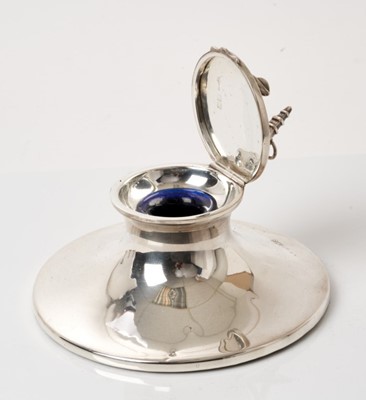 Lot 279 - Of Naval interest, silver capstan inkwell with anchor mount to lid, blue glass liner, (London 1913), 14cm diameter