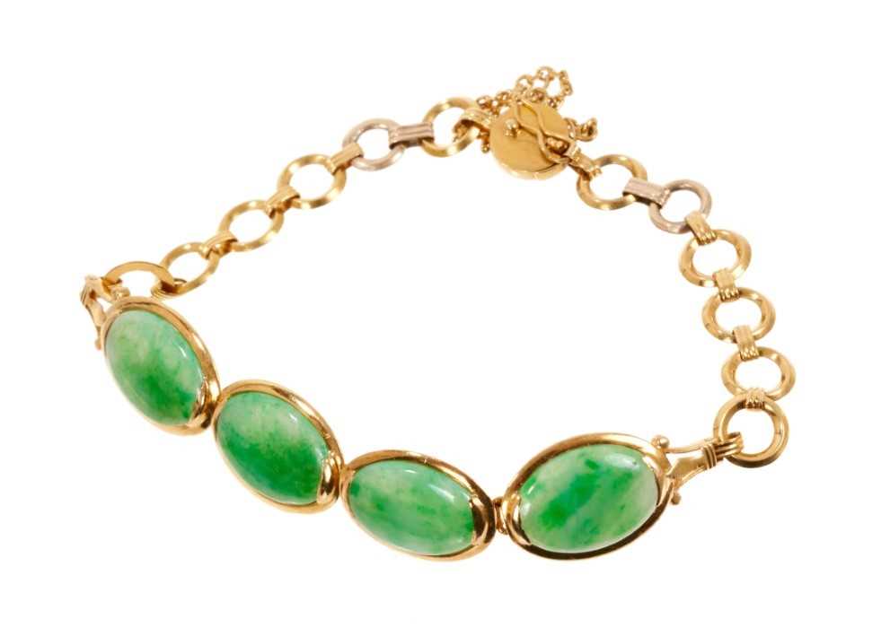 Lot 487 - Chinese green jade and gold bracelet with four oval green jade panels in gold setting, each panel measuring approximately 12.5mm x 10mm. Chinese hallmarks to the clasp. Length approximately 16cm.