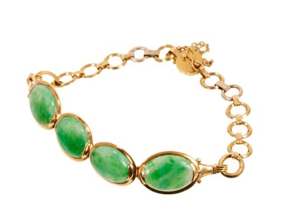 Lot 487 - Chinese green jade and gold bracelet with four oval green jade panels in gold setting, each panel measuring approximately 12.5mm x 10mm. Chinese hallmarks to the clasp. Length approximately 16cm.