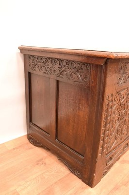 Lot 1421 - Large 17th century carved oak coffer, with plank lid and triple panel front raised on stiles with carved brackets, 151cm wide x 67cm deep x 70cm high