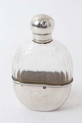 Lot 320 - Early 20th century French silver scent/spirit flask with cut glass body, screw fitting cap and glass stopper, the removable cup with engraved initials and marked with French control marks. 10.5cm...