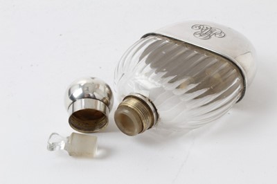 Lot 320 - Early 20th century French silver scent/spirit flask with cut glass body, screw fitting cap and glass stopper, the removable cup with engraved initials and marked with French control marks. 10.5cm...