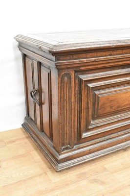 Lot 1466 - 17th century Continental oak cassone, of small size, with hinged lid and interior candle box, panelled front flanked by iron carrying handles, on stiles