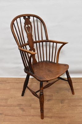 Lot 1470 - Early 19th century ash and elm Windsor chair, with stick back and pierced splat, solid saddle seat on splayed turned supports, with old blacksmiths repair to back leg