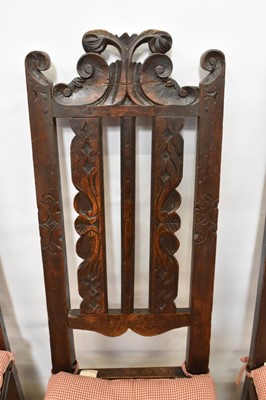 Lot 1479 - Set of four 17th century carved oak high dining chairs, each with pierced top rails and vertical splats, solid seat on turned and block under structure