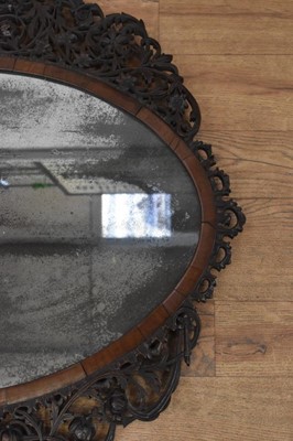 Lot 1488 - Fine 18th century Colonial hardwood wall mirror, with pleasantly distressed oval plate in cushion frame with ornate pierced surround, 77 x 78cm