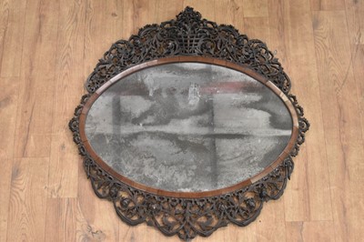 Lot 1488 - Fine 18th century Colonial hardwood wall mirror, with pleasantly distressed oval plate in cushion frame with ornate pierced surround, 77 x 78cm