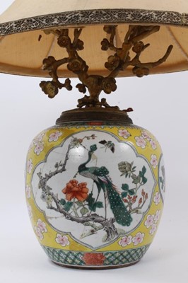 Lot 130 - Chinese famille jaune porcelain jar, decorated with panels containing flowers, insects and a peacock, on a yellow ground with prunus blossom, Qianlong seal mark to base but 19th century, converted...