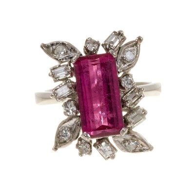 Lot 563 - Pink tourmaline and diamond cluster cocktail ring with a rectangular step cut pink tourmaline surrounded by single cut and baguette cut diamonds in white gold setting