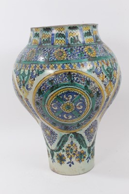 Lot 131 - A large tin glazed ceramic vase, probably 19th century Spanish, decorated with foliate patterns in yellow, green and blue, 45cm high
