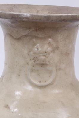 Lot 132 - Antique Chinese cream glazed stoneware vase, Qing or earlier, of baluster form with moulded mask and ring decoration, 31.5cm high