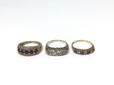Lot 8 - 9ct gold five stone ruby with diamond set borders, together with two other 9ct gold gem set rings (3)