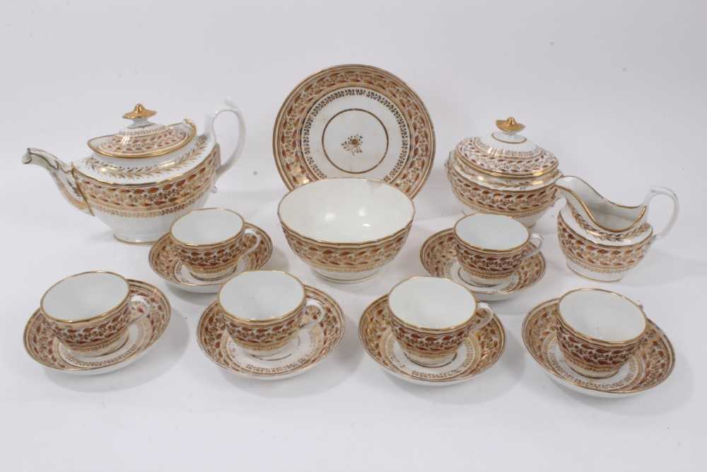 Lot 147 - A Chamberlain Worcester tea set, circa 1800, decorated in gilt and enamel with a foliate pattern, comprising a teapot, cream jug, sucrier, bowl, six cups, six saucers and a side dish
