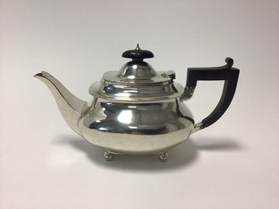 Lot 20 - George V sterling silver teapot, with ebony handle and knop, raised on ball feet, 24cm from spout to handle, Sheffield 1928 (Brook & Son), 19.5 oz