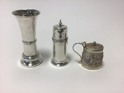 Lot 21 - George V sterling silver lighthouse caster, with reeded decoration, Birmingham 1915, 10cm high, 1.8 oz, together with a filled silver spill vase of waisted form and an Indian white metal mustard wi...