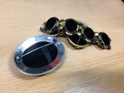 Lot 31 - Victorian black glass cameo bracelet in yellow metal setting together with a black onyx and silver brooch (2)