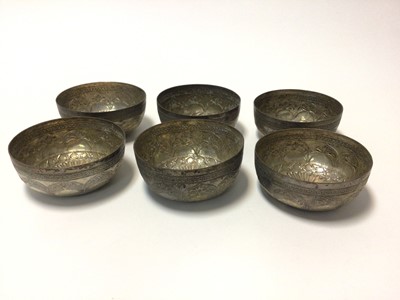 Lot 66 - Set of six Eastern white metal bowls, with foliate patterns in relief, 10cm diameter, total weight 10.5oz