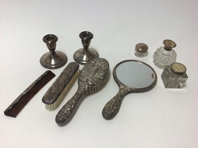 Lot 85 - Group of silver, including a pair of sterling weighted candlesticks, three silver-topped glass items, and a four-piece brush and comb set