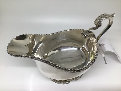 Lot 118 - George V silver gravy/sauce boat, scrolled handle, gadrooned rim and footrim with shell decoration to base, 17cm from spout to handle, Birmingham 1929 (Charles S. Green & Co), 10.5oz