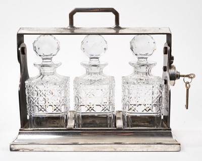 Lot 987 - Edwardian three bottle silver plated tantalus