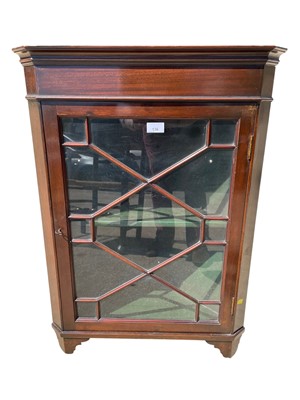 Lot 136 - Edwardian mahogany hanging corner cupboard with retailers label for Simkin of Colchester, 80cm high