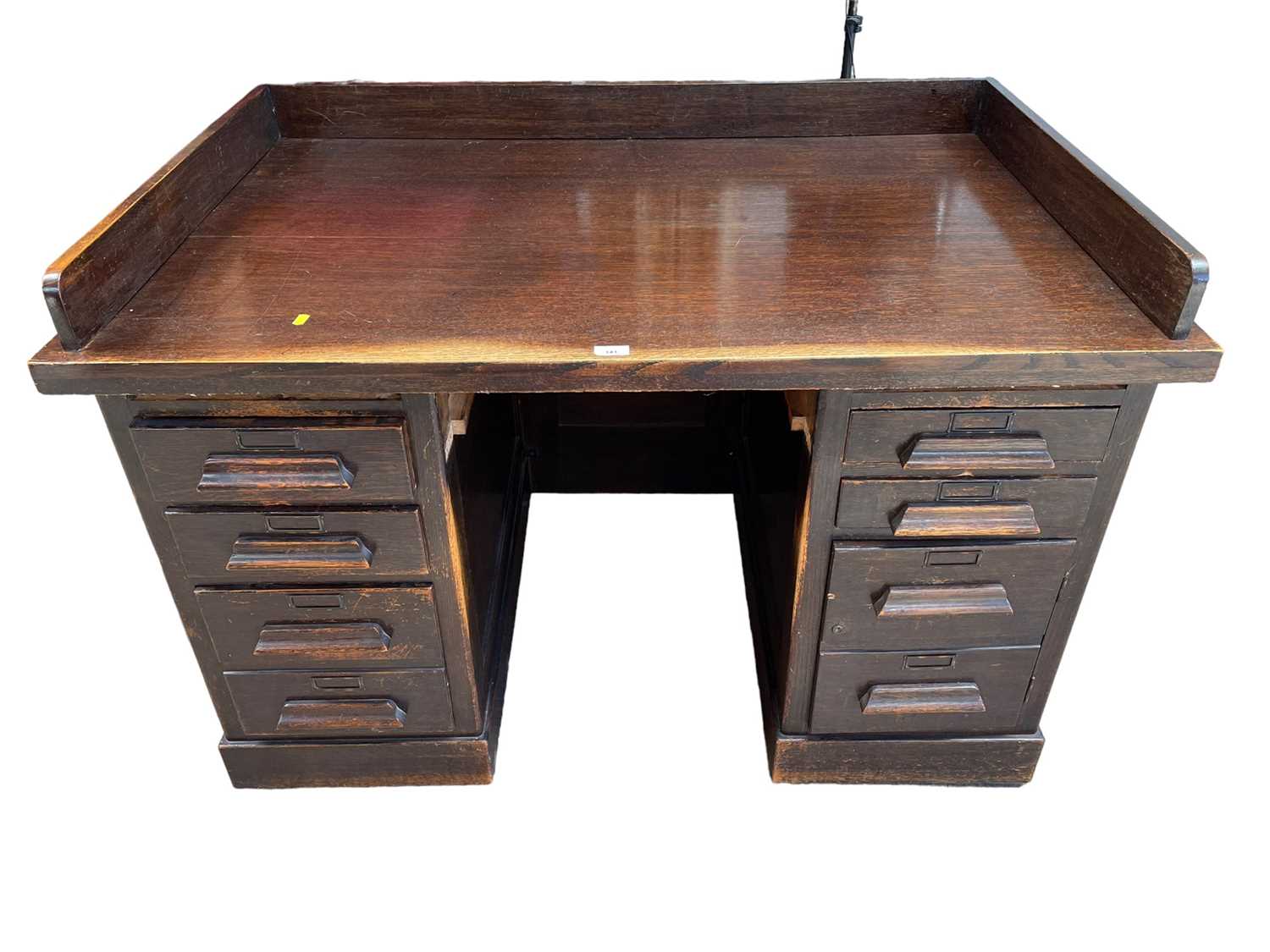 Lot 141 - 1920s oak twin pedestal desk with an arrangement of drawers